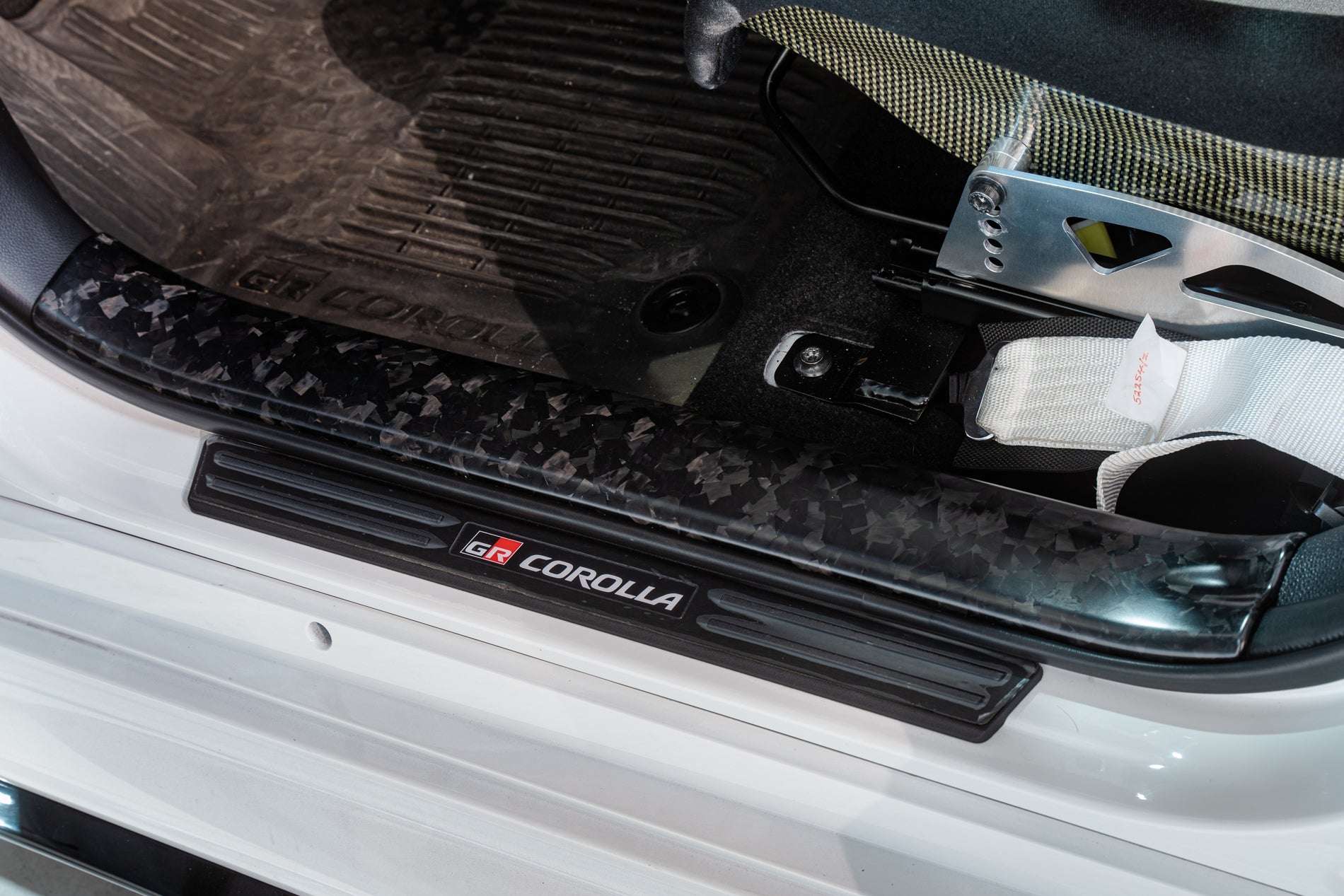 TOM'S RACING FORGED CARBON FRONT SCUFF PLATE COVER - COROLLA HATCHBACK [2019+]